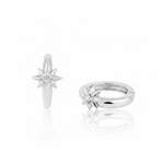 white gold star huggie earrings on white background