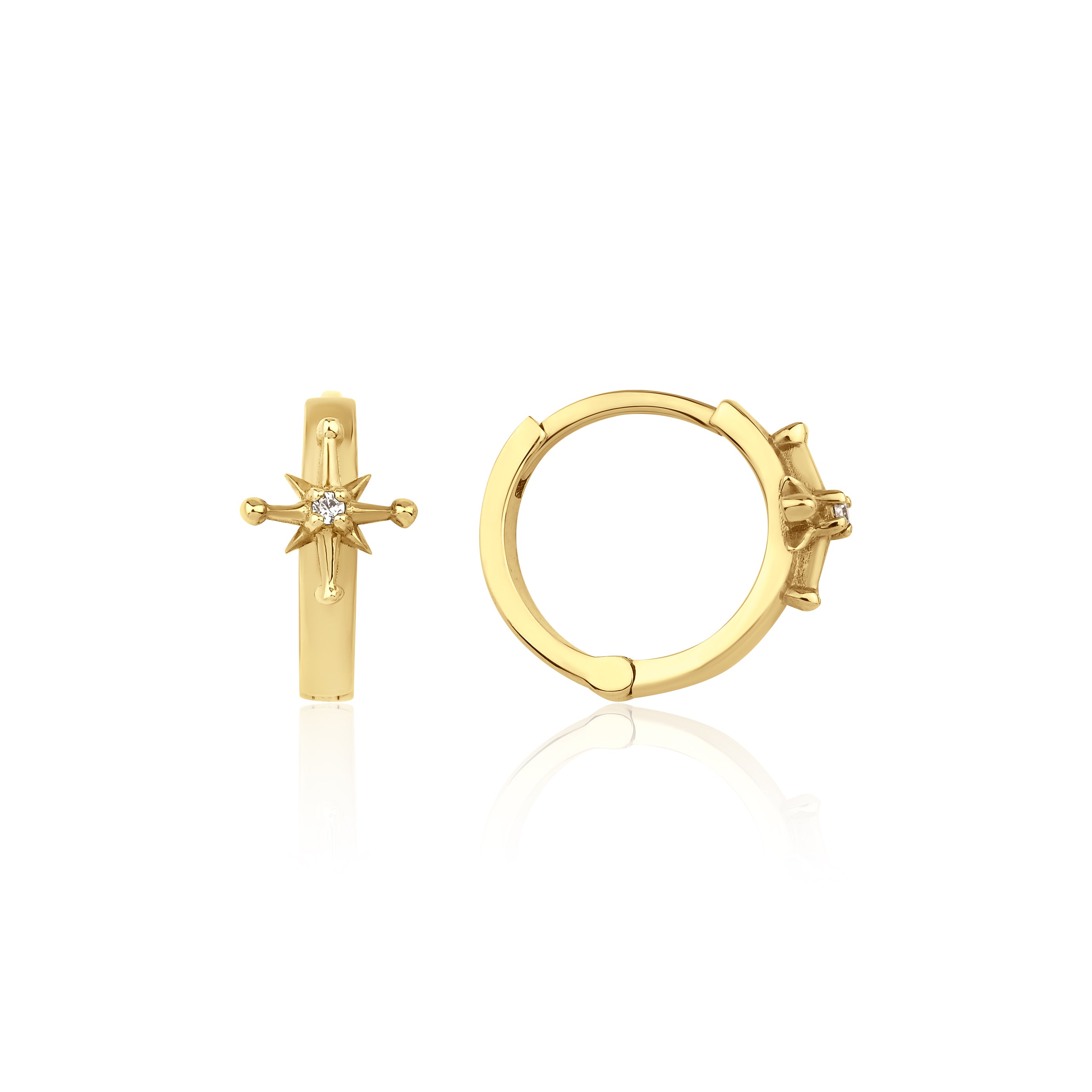 yellow gold starburst huggie earrings on white background