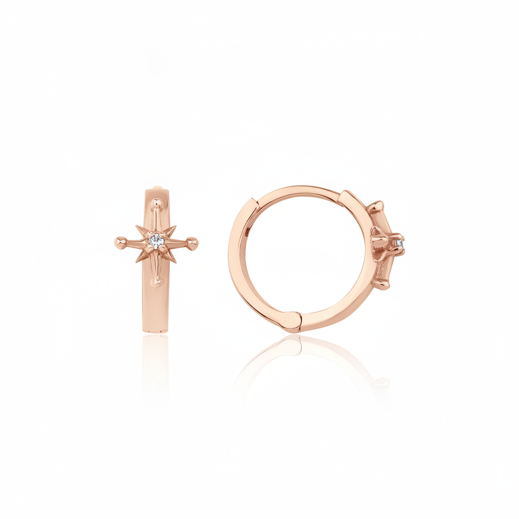 rose gold starburst huggie earrings on white background