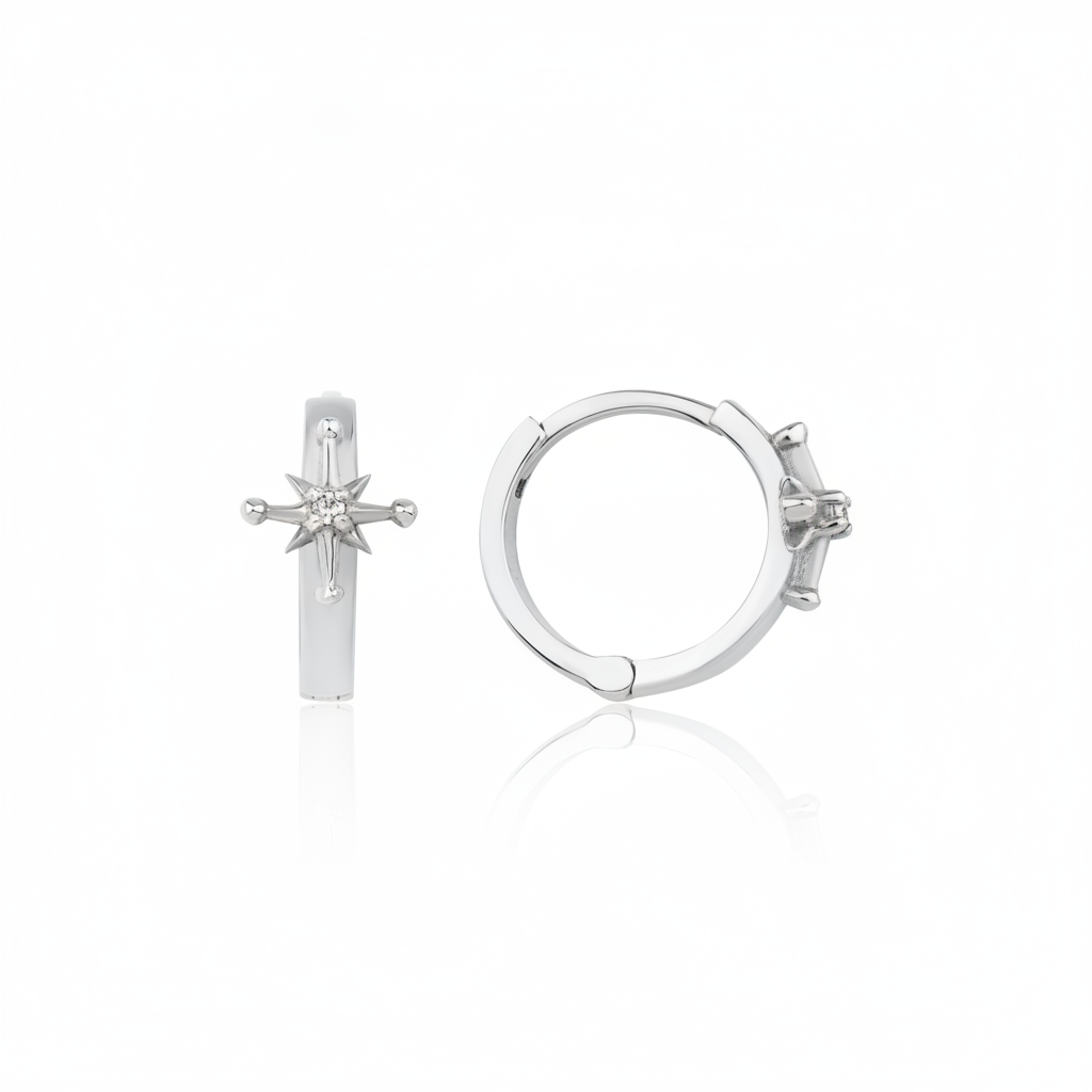 white gold starburst huggie earrings on white background