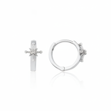 white gold starburst huggie earrings on white background