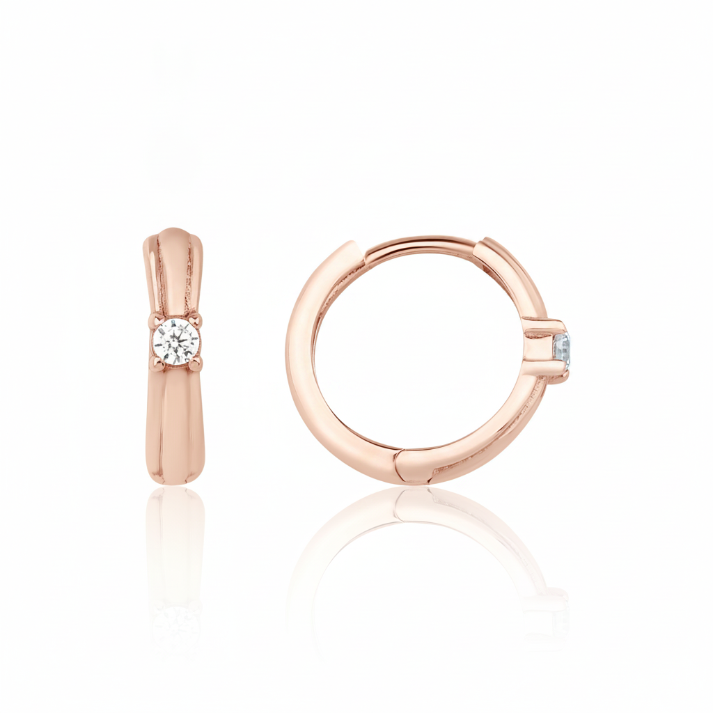 rose gold solitaire huggie earrings on white background