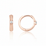 rose gold solitaire huggie earrings on white background