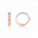 rose gold solitaire huggie earrings on white background