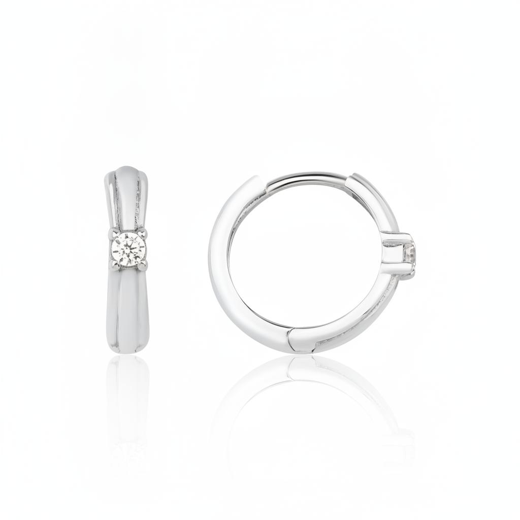 white gold solitaire huggie earrings on white background