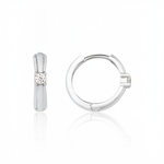 white gold solitaire huggie earrings on white background