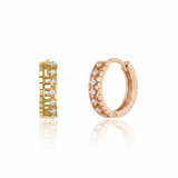 rose gold notched huggie earrings on white background