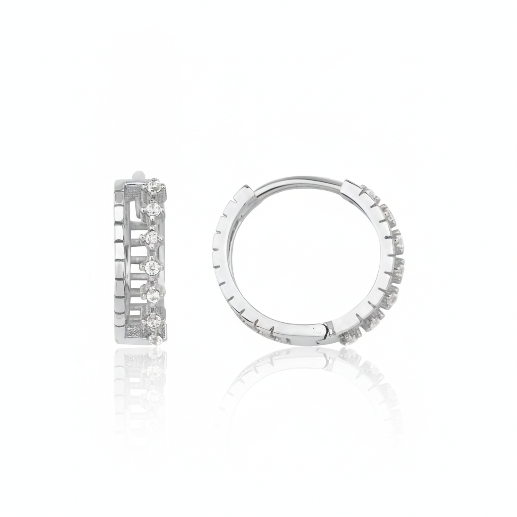white gold notched huggie earrings on white background