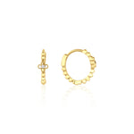 yellow gold quatrefoil huggie earrings on white background