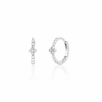 white gold quatrefoil huggie earrings on white background