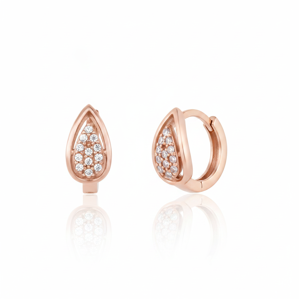 rose gold drop pave huggie earrings on white background