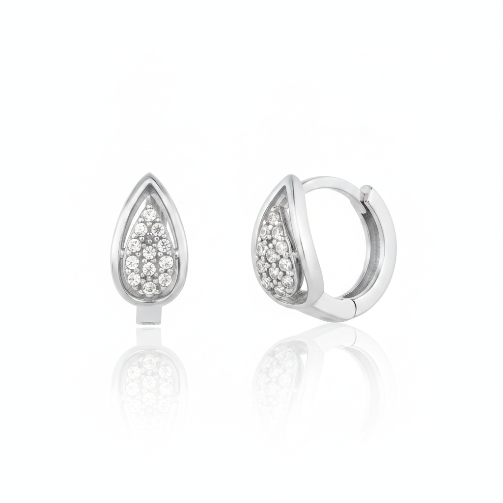 white gold drop pave huggie earrings on white background