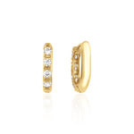 yellow gold quad spark huggie earrings on white background