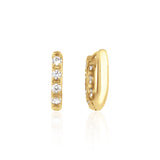 yellow gold quad spark huggie earrings on white background