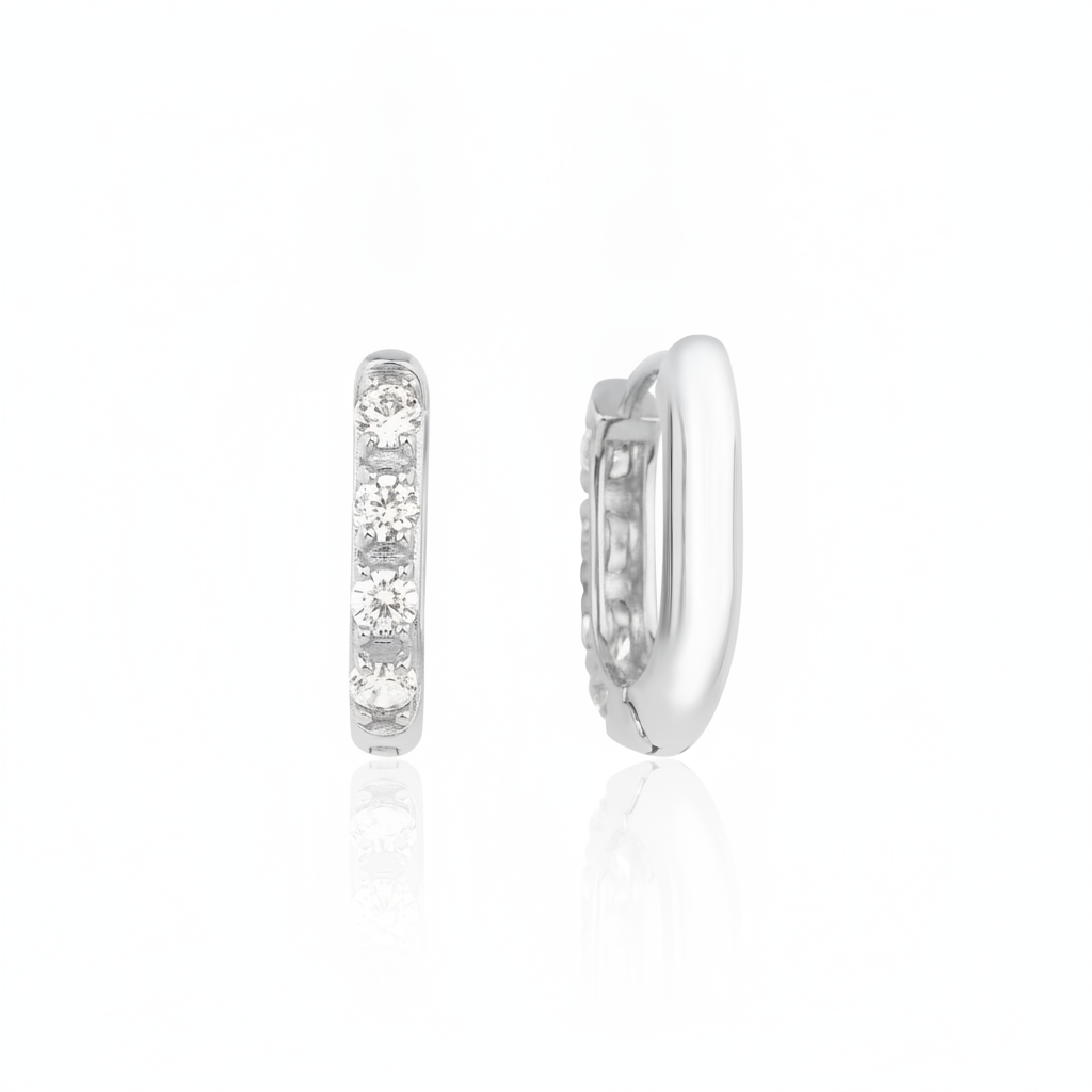 white gold quad spark huggie earrings on white background