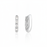 white gold quad spark huggie earrings on white background