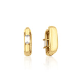 yellow gold baguette huggie earrings on white background