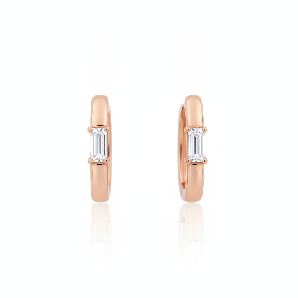rose gold baguette huggie earrings on white background