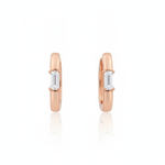 rose gold baguette huggie earrings on white background