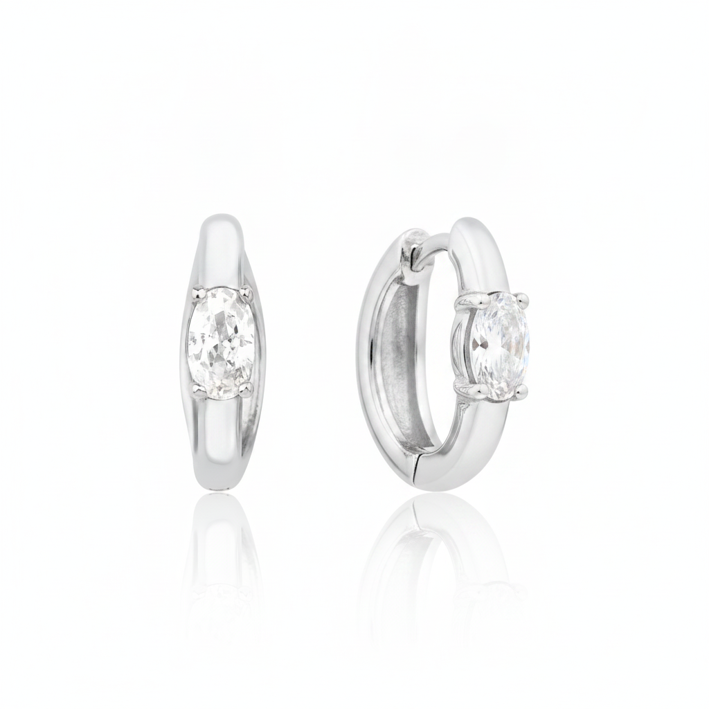 white gold oval stone huggie earrings on white background
