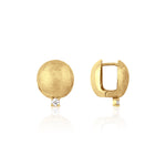 yellow gold brushed disc huggie hoop earrings with a single clear stone on white background