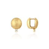 yellow gold brushed disc huggie hoop earrings with a single clear stone on white background