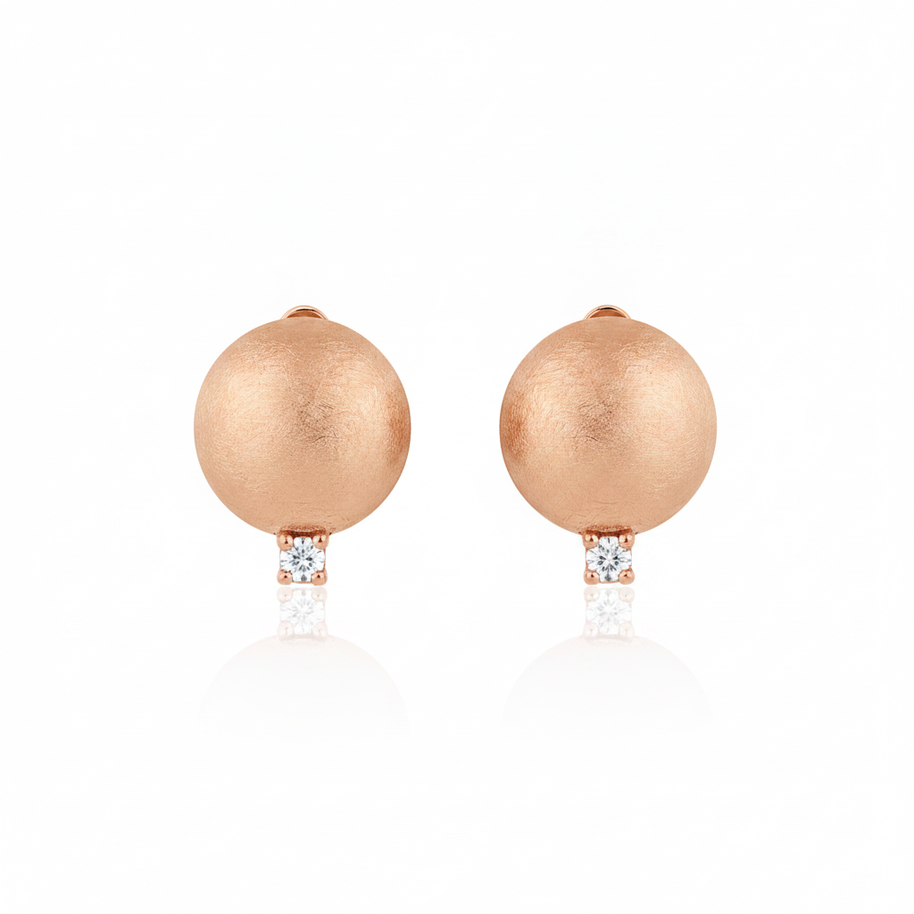 rose gold brushed disc huggie hoop earrings with a single clear stone on white background