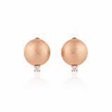 rose gold brushed disc huggie hoop earrings with a single clear stone on white background