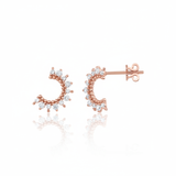 rose gold crescent stud earrings with clear stones on white background