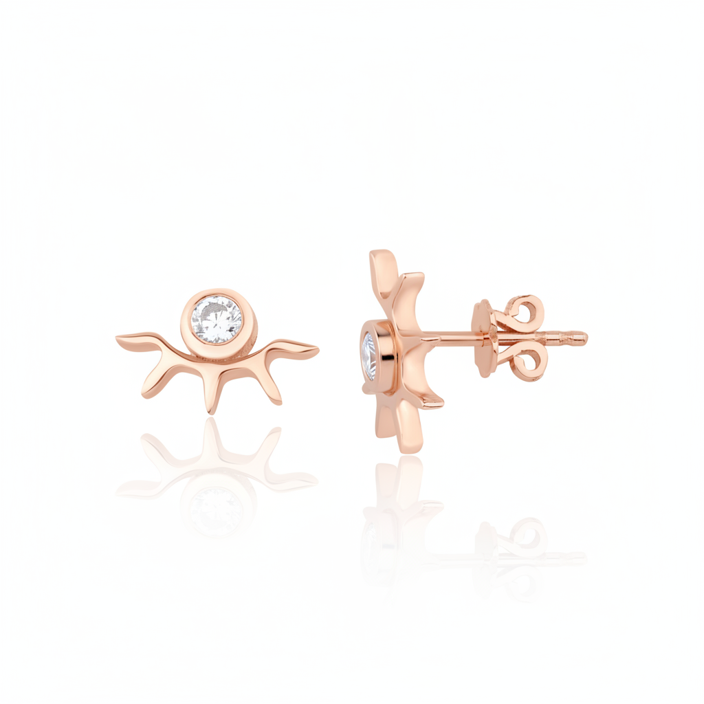 rose gold sunburst stud earrings with a bezel-set clear stone on white background