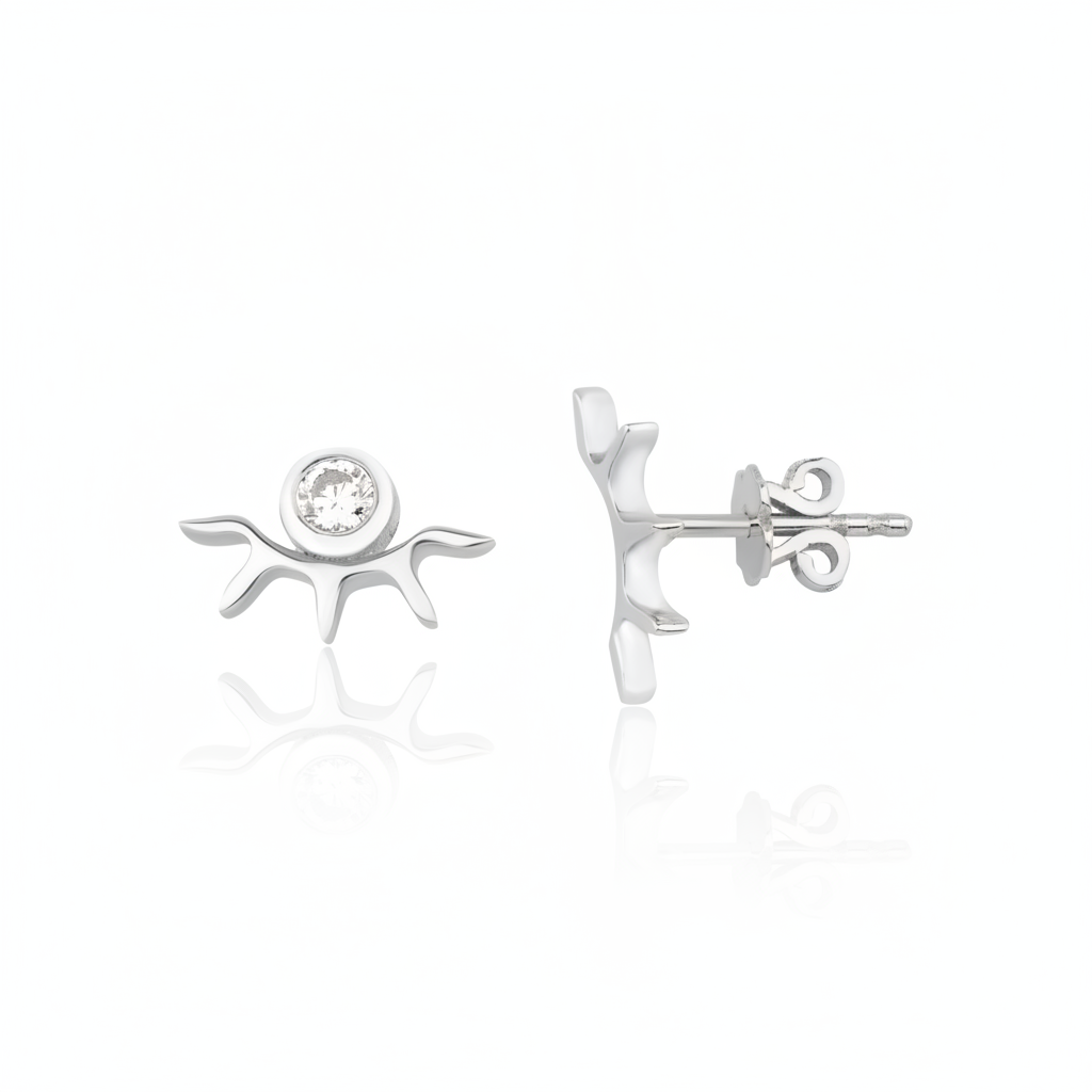 white gold sunburst stud earrings with a bezel-set clear stone on white background