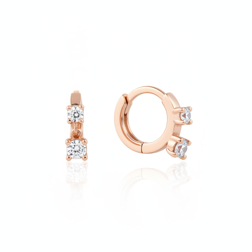 rose gold huggie hoop earrings with two cascading clear stones on white background