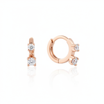 rose gold huggie hoop earrings with two cascading clear stones on white background