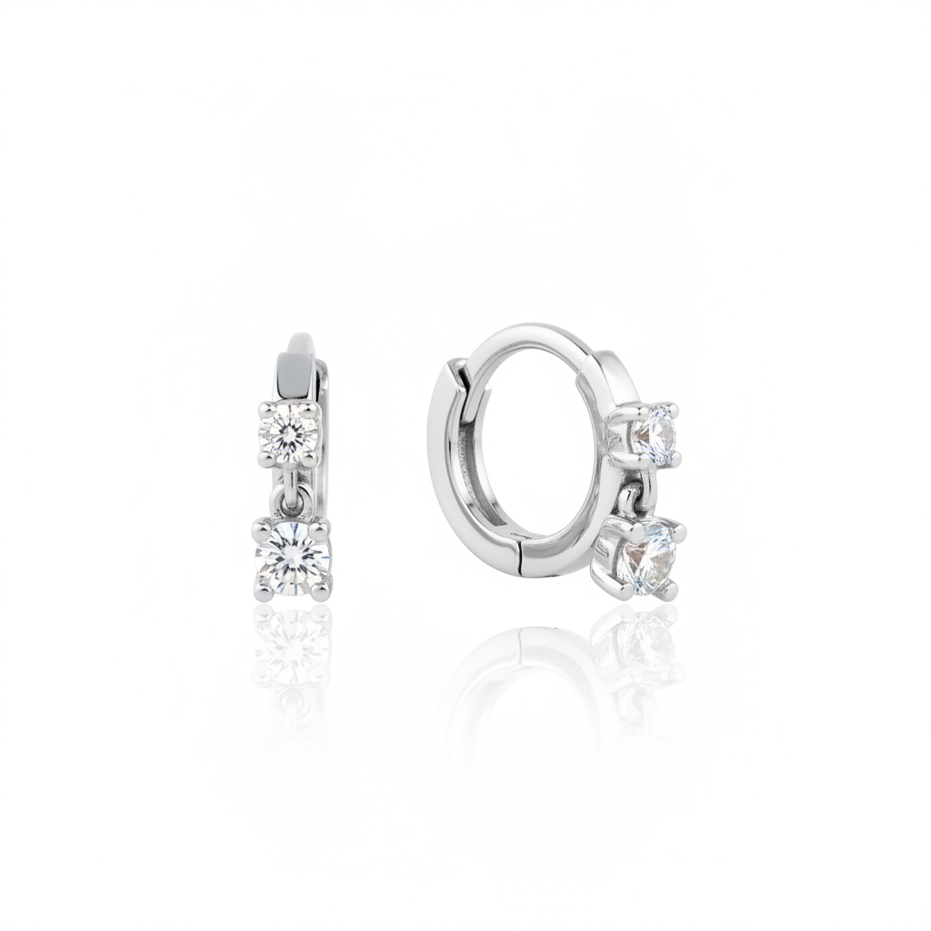 white gold huggie hoop earrings with two cascading clear stones on white background