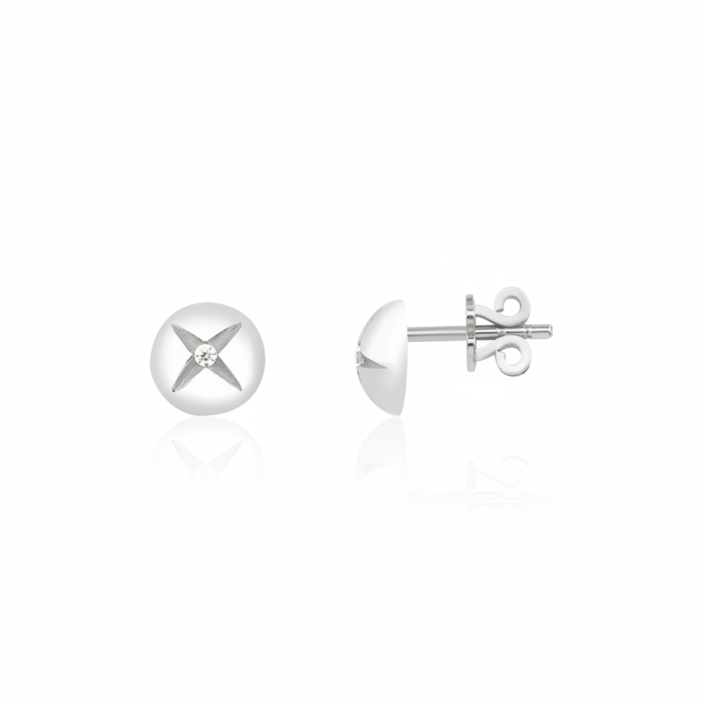 white gold star-etched dome stud earrings with a single clear stone on white background