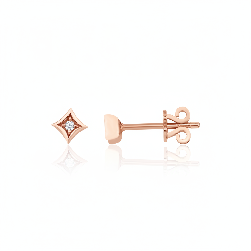 rose gold star-shaped stud earrings with a single clear stone on white background