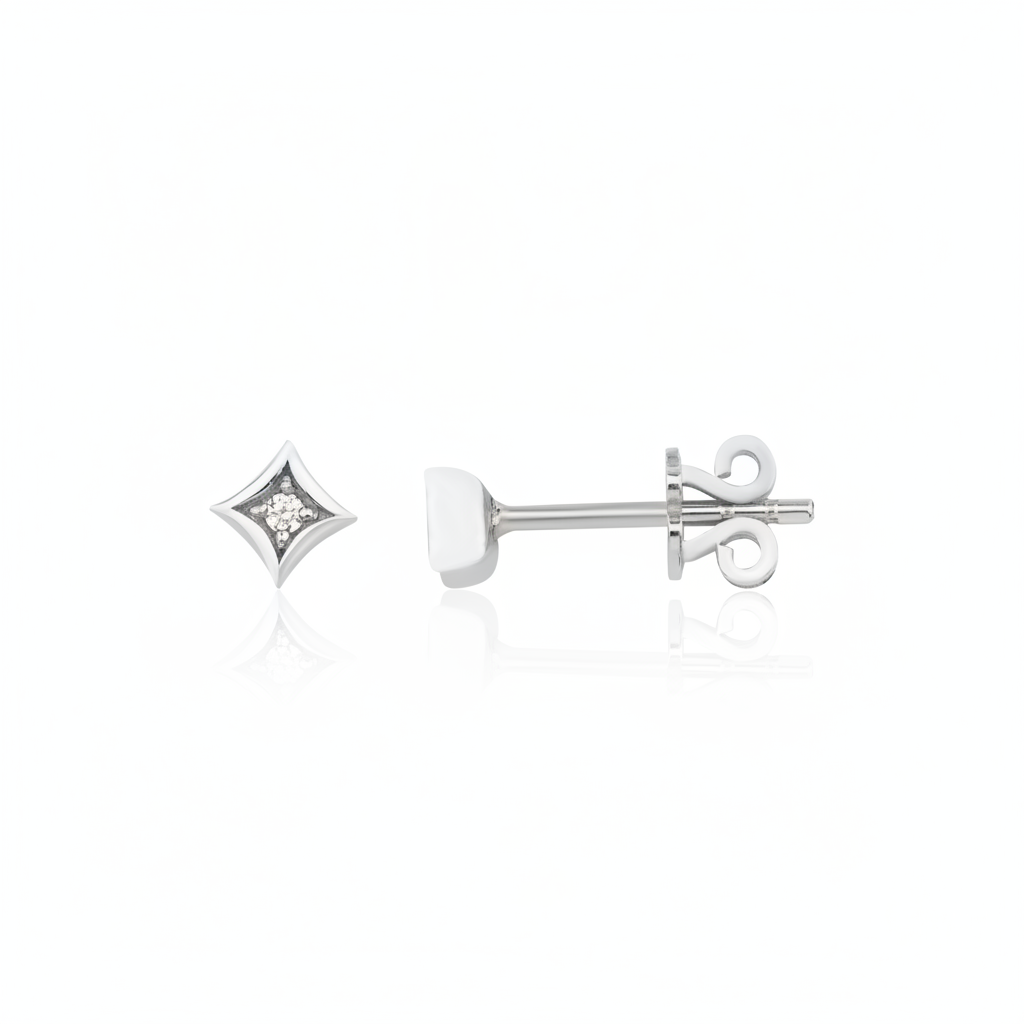white gold star-shaped stud earrings with a single clear stone on white background
