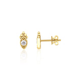 yellow gold almond-shaped stud earrings with a central clear stone on white background