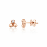 rose gold triple sphere stud earrings with a single clear stone on white background