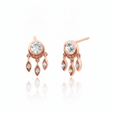 rose gold stud earrings with dangling leaf charms and clear stones on white background