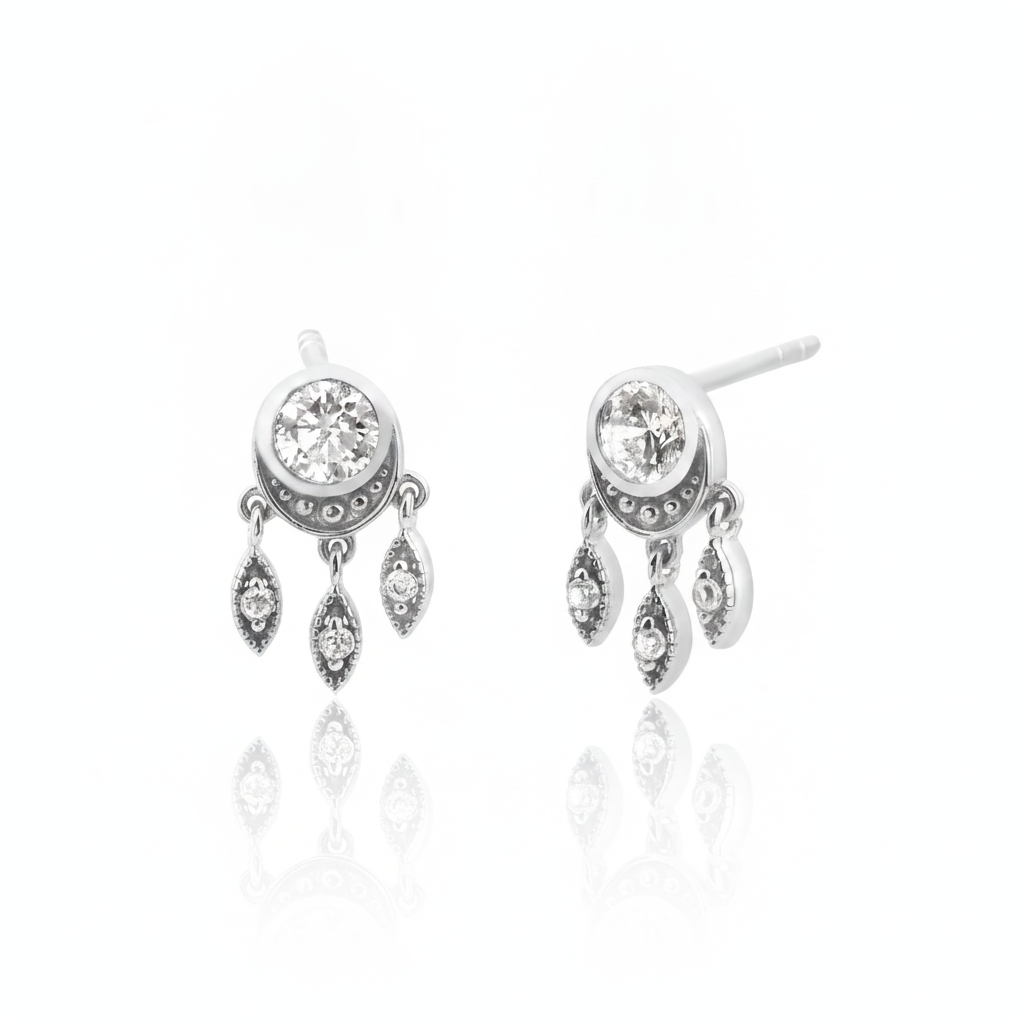 white gold stud earrings with dangling leaf charms and clear stones on white background