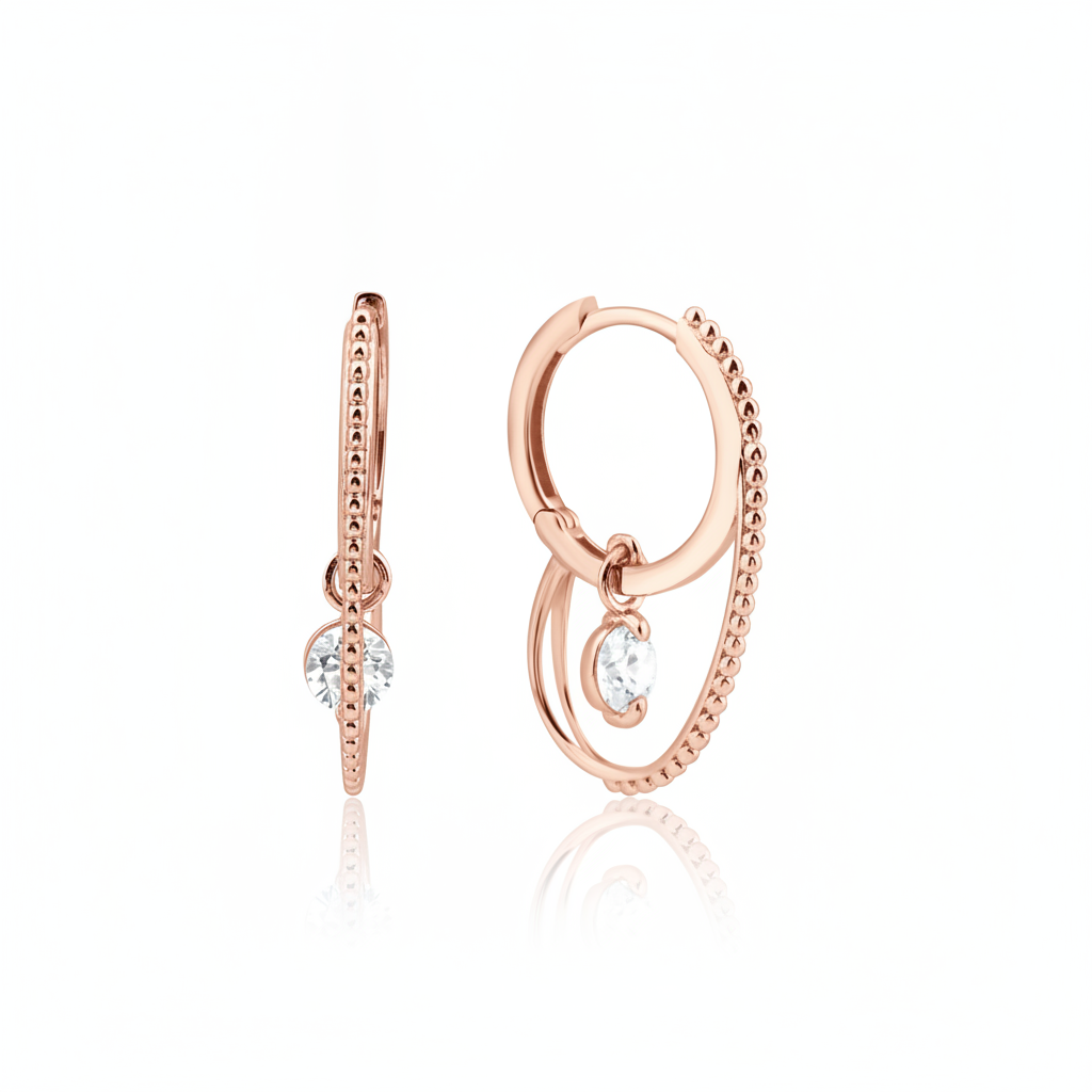 rose gold double hoop earrings with a dangling clear round stone on white background