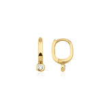 yellow gold oval huggie earrings with a bezel-set clear stone on white background
