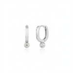 white gold oval huggie earrings with a bezel-set clear stone on white background