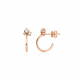 rose gold open hoop earrings with cluster of stones on white background