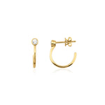 yellow gold open hoop earrings with bezel-set stone on white background