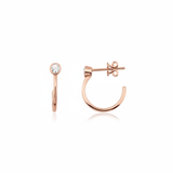 rose gold open hoop earrings with bezel-set stone on white background