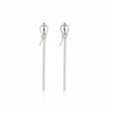 white gold knot huggie hoop earrings with drop chains on white background