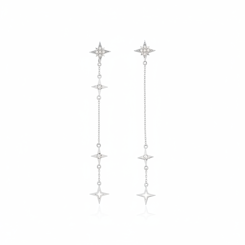 white gold asymmetrical starburst drop earrings on white background