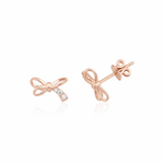 rose gold bow stud earrings with accent stones on white background